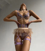 Ensemble de lingerie sexy quatre pièces violet brodé, comprenant jupe, string et tanga.